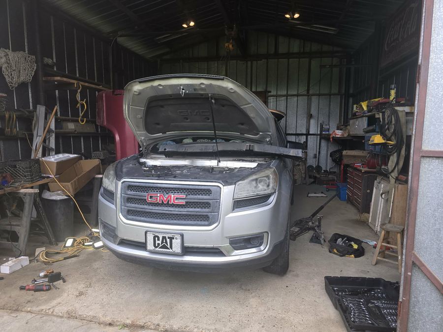GMC Acadia with the front end disassembled during a repair
