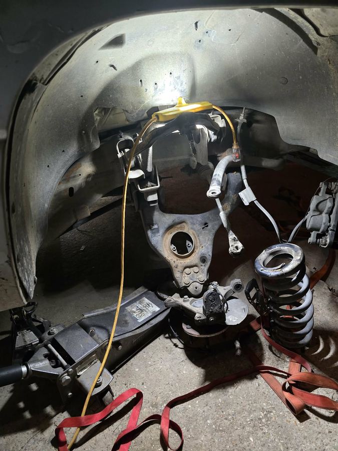 Front suspension stripped down with the coil spring and steering knuckle removed