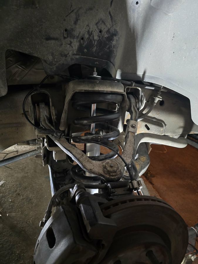 Underside view of a front suspension with a newly fitted shock absorber